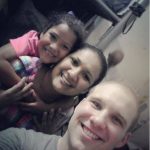 Josh Holt poses with his wife Thamy and her daughter Nathalia inside the prison at El Helicoide in Caracas on Christmas Eve, 2016.  (Instagram Photo/Thamy Holt)