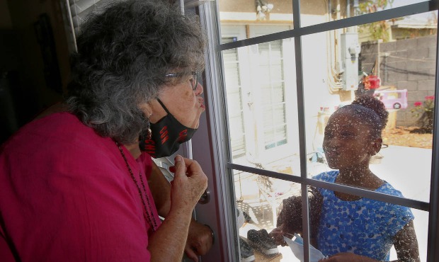 Zita Robinson, left, who's 77 and diabetic, blows a kiss to her granddaughter Traris "Trary" Robins...