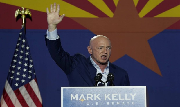 Mark Kelly, Arizona Democratic candidate for U.S. Senate, waves to supporters as he speaks during a...