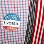 An "I voted" sticker is placed on Eddie Slades shirt at Burton Barr Central Library on November 3, 2020 in Phoenix, Arizona. After a record-breaking early voting turnout, Americans head to the polls on the last day to cast their vote for incumbent U.S. President Donald Trump or Democratic nominee Joe Biden in the 2020 presidential election. (Getty Images Photo/Courtney Pedroza/Getty Images)