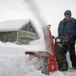 Truman Jones clears a driveway in Bellemont, Ariz., Tuesday, Jan. 26, 2021. Residents were digging out from a major winter storm that dumped heavy snow in the region. (AP Photo/Felicia Fonseca)