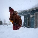 Tim Ahlman shovels snow outside his home in Bellemont, Ariz. Monday, Jan. 25, 2021. A series of winter storms have dropped more precipitation in Flagstaff than the city had during last summer's monsoon season. The recent snow measured as water topped the amount of rain that fell from mid-June through September, the driest monsoon season on record. (AP Photo/Felicia Fonseca)