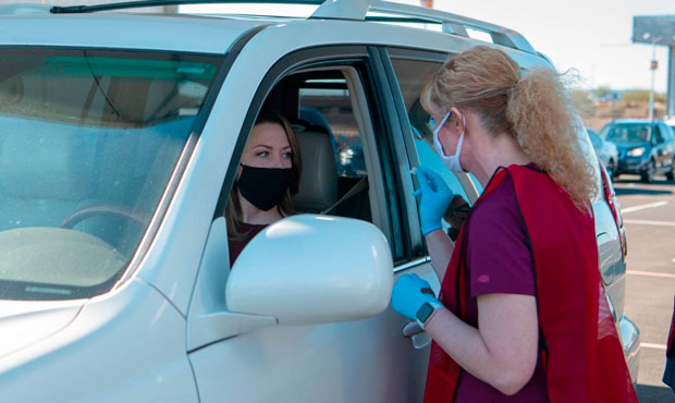 Arizona Department of Health Services Director Dr. Cara Christ works at the state-run COVID-19 vacc...