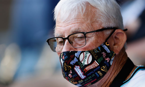 A fan wearing a facemask attends the MLB game between the Arizona Diamondbacks and the Cincinnati R...