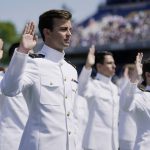 
              Graduating U.S. Naval Academy midshipmen raise their right hands as they are commissioned at the graduation and commission ceremony at the U.S. Naval Academy in Annapolis, Md., Friday, May 28, 2021. (AP Photo/Julio Cortez)
            