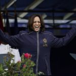 
              Vice President Kamala Harris displays her U.S. Naval Academy jacket at the graduation and commission ceremony at the U.S. Naval Academy in Annapolis, Md., Friday, May 28, 2021. Harris is the first woman to give the graduation speech at the Naval Academy. (AP Photo/Julio Cortez)
            