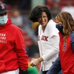 
              Director of the Centers for Disease Control and Prevention Rochelle Walensky, center, walks off the field after throwing out the ceremonial first pitch to Boston Red Sox's Christian Vazquez, left, before a baseball game against the Miami Marlins, Saturday, May 29, 2021, in Boston. (AP Photo/Michael Dwyer)
            