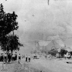 
              FILE - This photo provided by the Department of Special Collections, McFarlin Library, The University of Tulsa shows a crowd watching the Mt. Zion Baptist Church burn during the June 1, 1921, Tulsa Race Massacre in Tulsa, Okla. (Department of Special Collections, McFarlin Library, The University of Tulsa via AP, File)
            