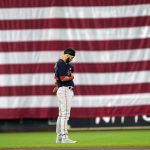 
              Boston Red Sox's Marwin Gonzalez pauses during a moment of silence in honor of Memorial Day before a baseball game against the Houston Astros Monday, May 31, 2021, in Houston. (AP Photo/David J. Phillip)
            