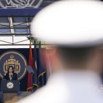 
              A Navy officer stands guard as Vice President Kamala Harris, left, speaks at the graduation and commission ceremony at the U.S. Naval Academy in Annapolis, Md., Friday, May 28, 2021. Harris is the first woman to give the graduation speech at the Naval Academy. (AP Photo/Julio Cortez)
            