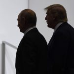 
              FILE - In this June 28, 2019, file photo, President Donald Trump and Russian President Vladimir Putin walk to participate in a group photo at the G20 summit in Osaka, Japan.  (AP Photo/Susan Walsh, File)
            