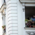 Nathalie Sartor, 57, tends her window boxes in her apartment in Montmartre, Paris, on May 31, 2021. One of the last things she did before France first locked down in March 2020 against the coronavirus pandemic was to rush out and buy soil and seeds for the window gardens that she lovingly tended during the months sealed away. "I seeded my flowers. They grew. It was a huge pleasure," she says. (AP Photo/ Joao Luiz Bulcao)
