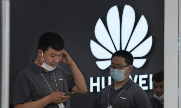 Huawei store workers wait for customers in Beijing on Wednesday, June 2, 2021. Huawei is launching ...