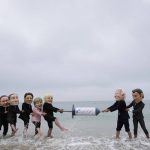 Activists wearing giant heads of the G7 leaders tussle over a giant COVID-19 vaccine syringe during an action of NGO's on Swanpool Beach in Falmouth, Cornwall, England, Friday, June 11, 2021. Leaders of the G7 begin their first of three days of meetings on Friday in Carbis Bay, in which they will discuss COVID-19, climate, foreign policy and the economy. Depicted from left to right, Japan's Prime Minister Yoshihide Suga, Italy's Prime Minister Mario Draghi, Canadian Prime Minister Justin Trudeau, German Chancellor Angela Merkel, British Prime Minister Boris Johnson, U.S. President Joe Biden and French President Emmanuel Macron. (AP Photo/Kirsty Wigglesworth)
