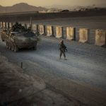 
              FILE - In this Aug. 8, 2009, file photo, U.S. soldiers from the 5th Striker Brigades walk next to armored vehicles as they arrive at their base on the outskirts of Spin Boldak, about 100 kilometers (63 miles) southeast of Kandahar, Afghanistan. President Joe Biden and his NATO counterparts bid a symbolic farewell to Afghanistan on Monday, June 14, in their last summit before America winds up its longest “forever war” and the military pulls out for good. (AP Photo/Emilio Morenatti, File)
            