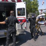 
              Salem Fire Department paramedics and employees of Falck Northwest ambulances respond to a heat exposure call during a heat wave, Saturday, June 26, 2021, in Salem, Ore. (AP Photo/Nathan Howard)
            