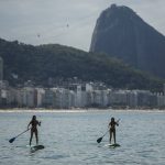 
              Women paddle their stand-up paddle boards off Copacabana beach in Rio de Janeiro, Brazil, May 16, 2021. Brazilian pop star Anitta’s spin on the classic “The Girl from Ipanema” Bossa Nova song provides a new vision of women in Rio de Janeiro compared to the 1960s original. (AP Photo/Bruna Prado)
            
