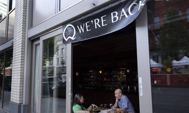 FILE - In this June 4, 2021, file photo, people dine at the Q restaurant and bar after a reopening ...