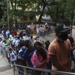 
              FILE - In this June 11, 2021, file photo, students wait to receive the Covishield, Serum Institute of India's version of the AstraZeneca vaccine, during a special vaccination drive for students traveling overseas, in Hyderabad, India. Starting June 21, 2021, every Indian adult can get a COVID-19 vaccine dose for free that was purchased by the federal government. The policy reversal announced last week ends a complex system of buying vaccines that worsened inequities in accessing vaccines. India is a key global supplier of vaccines and its missteps have left millions of people waiting unprotected. The policy change is likely to address inequality but questions remain and shortages will continue. (AP Photo/Mahesh Kumar A, File)
            