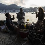 
              Gilberto, left, eat and drinks with his wife and friends in the Urca neighborhood of Rio de Janeiro, Brazil, Sunday, May 16, 2021. Brazilian pop star Anitta’s spin on the classic “The Girl from Ipanema” Bossa Nova song provides a new vision of women in Rio de Janeiro compared to the 1960s original.  (AP Photo/Bruna Prado)
            