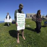 
              Climate activists hold signs as they demonstrates on a hillside outside the G7 meeting in St. Ives, Cornwall, England, Sunday, June 13, 2021. Leaders of the G7 wrap up three days of meetings in Carbis Bay Sunday, in which they discussed such topics as COVID-19, climate, foreign policy and the economy. (AP Photo/Jon Super)
            
