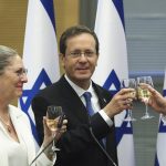 
              President-elect Isaac Herzog and his wife Michal celebrate after a special session of the Knesset whereby Israeli lawmakers elected the new president, at the Knesset, Israel's parliament, in Jerusalem Wednesday, June 2, 2021. (Ronen Zvulun/Pool Photo via AP)
            