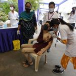 
              A physically disabled man gets a dose of Covishield, Serum Institute of India's version of the AstraZeneca COVID-19 vaccine, during a drive through vaccination organized for disabled people in Ahmedabad, India, Saturday, June 12, 2021. (AP Photo/Ajit Solanki)
            