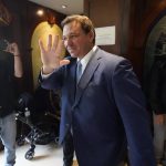 
              Florida Gov. Ron DeSantis, waves as he arrives, Monday, June 14, 2021, at the Shul of Bal Harbour, a Jewish community center in Surfside, Fla. DeSantis visited the South Florida temple to denounce anti-Semitism and stand with Israel, while signing a bill into law that would require public schools in his state to set aside moments of silence for children to meditate or pray. (AP Photo/Wilfredo Lee)
            