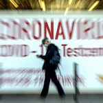 
              In this Feb.25, 2021 file photo a man walks by a sign in the window of a Coronavirus testing center in Frankfurt, Germany. (AP Photo/Michael Probst, file)
            