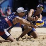 
              Philip Dalhausser, right, of the United States, and teammate Nicholas Lucena, converge on the ball during a men's beach volleyball match against Qatar at the 2020 Summer Olympics, Sunday, Aug. 1, 2021, in Tokyo, Japan. (AP Photo/Felipe Dana)
            