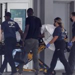 
              Martine Moise, first lady of Haiti, arrives at Jackson Health System's Ryder Trauma Center, in Miami, for treatment, Wednesday, July 7, 2021, after being shot multiple times at her home earlier in the day in Port-au-Prince, Haiti. Her husband, Haitian President Jovenel Moise, was assassinated at their home. (Carl Juste/Miami Herald via AP)
            