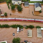 
              A regional train sits in the flood waters at the local station in Kordel, Germany, Thursday July 15, 2021 after it was flooded by the high waters of the Kyll river. (Sebastian Schmitt/dpa via AP)
            