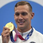 
              Caeleb Dressel of the United States poses with his gold medal for the men's 100-meter freestyle at the 2020 Summer Olympics, Thursday, July 29, 2021, in Tokyo, Japan. (AP Photo/Matthias Schrader)
            