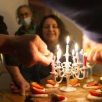 
              Nathalie Sartor, center, smiles as candles are lit to celebrate her 57th birthday in the apartment that she and her family share in Montmartre, Paris, on May 14, 2021. France began easing out of lockdown in mid-May, as vaccinations started to make headway against the country's coronavirus epidemic that has claimed more 110,000 lives. With shops, museums, cafes and restaurants open again, Nathalie is looking forward to taking a road trip through France in the coming summer months.(AP Photo/Joao Luiz Bulcao)
            