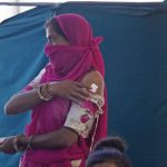 
              A woman stands after getting vaccinated for COVID-19 at a vaccination centre in Ahmedabad, India, Friday, July 16, 2021. (AP Photo/Ajit Solanki)
            