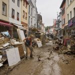 
              Residents and shopkeepers are trying to clear mud from their homes and move unusable furniture outside in Ahrweiler, western Germany, Saturday, July 17, 2021. Heavy rains caused mudslides and flooding in the western part of Germany. Multiple have died and are missing as severe flooding in Germany and Belgium turned streams and streets into raging, debris-filled torrents that swept away cars and toppled houses. (Thomas Frey/dpa via AP)
            