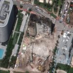 
              In this satellite image provided by Maxar Technologies heavy-lift cranes are used to aid in the search and recovery operation at the partially collapsed Champlain Towers South condo building on Saturday, July 3, 2021, in Surfside, Fla. (Maxar Technologies via AP)
            