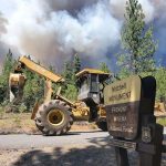 
              In this photo provided by the Bootleg Fire Incident Command, the Bootleg Fire burns behind heavy equipment at the Mitchell Monument in southern Oregon on Saturday, July 17, 2021. The 569-square-mile (1,474 square kilometers) Bootleg Fire is burning 300 miles (483 kilometers) southeast of Portland in and around the Fremont-Winema National Forest, a vast expanse of old-growth forest, lakes and wildlife refuges. (Bootleg Fire Incident Command via AP)
            