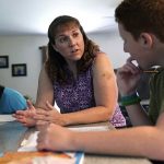 
              Jennifer Osgood, center, teaches her son, Noah, 12, while reviewing school work at their home in Fairfax, Vt., on Tuesday, July 20, 2021. The U.S. Census Bureau reported in March that the rate of households homeschooling their children rose to 11% by September 2020, more than doubling from 5.4% just six months earlier. (AP Photo/Charles Krupa)
            