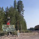 
              A sign thanking firefighters and first responders hangs near the Bootleg Fire, Monday, July 12, 2021, in Chiloquin, Ore. (AP Photo/Nathan Howard)
            