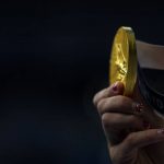 
              Kathleen Ledecky, of United States, shows her gold medal after winning the women's 800-meter freestyle final at the 2020 Summer Olympics, Saturday, July 31, 2021, in Tokyo, Japan. (AP Photo/David Goldman)
            