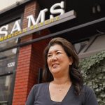 Jeannie Kim poses outside her restaurant in San Francisco on Friday, July 30, 2021. Thanks to a reworked menu and long hours, Jeannie Kim managed to keep her San Francisco restaurant alive during the coronavirus pandemic. That makes it all the more frustrating that she fears her breakfast-focused diner could be ruined within months by new rules that could make one of her top menu items -- bacon -- hard to get in California. (AP Photo/Eric Risberg)