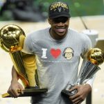 
              Milwaukee Bucks forward Giannis Antetokounmpo smiles while holding the NBA Championship trophy, left, and Most Valuable Player trophy after defeating the Phoenix Suns in Game 6 of basketball's NBA Finals in Milwaukee, Tuesday, July 20, 2021. The Bucks won 105-98. (AP Photo/Paul Sancya)
            