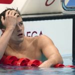 
              Nic Fink of the United States rests after his swim in the men's 200-meter breaststroke final at the 2020 Summer Olympics, Thursday, July 29, 2021, in Tokyo, Japan. (AP Photo/Matthias Schrader)
            