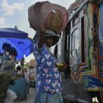 
              A street vendor hawking bananas waits for customers at a bus terminal in Port-au-Prince, Haiti, Saturday, July 10, 2021, three days after President Jovenel Moise was assassinated in his home. (AP Photo /Matias Delacroix)
            