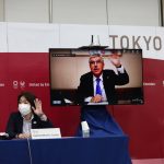 
              International Olympic Committee (IOC) president Thomas Bach (on-screen) and Tokyo 2020 president Seiko Hashimoto, left, wave at the beginning of the five-party meeting in Tokyo, Thursday, July 8, 2021. (Behrouz Mehri/Pool Photo via AP)
            