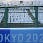 
              Games staff sit in the empty stands during the softball game between the Mexico and Japan at the 2020 Summer Olympics, Thursday, July 22, 2021, in Fukushima , Japan. (AP Photo/Jae C. Hong)
            