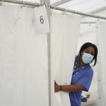 
              An NHS nurse looks for patients at a pop-up vaccination centre during a four-day Covid-19 vaccine festival in Langdon Park, east London, Saturday July 31, 2021.  The authorities are implementing a program of short term pop-up vaccination sites in an attempt to prompt people to get the jab. (Kirsty O'Connor/PA via AP)
            