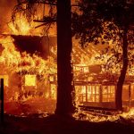 
              Flames from the Dixie Fire consume a home in the Indian Falls community of Plumas County, Calif., Saturday, July 24, 2021. The fire destroyed multiple residences as it tore through the area. (AP Photo/Noah Berger)
            