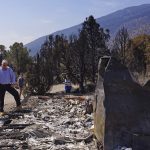 
              California Gov. Gavin Newsom, left, and Nevada Gov. Steve Sisolak talk as they tour destroyed home by wildfires near where the Tamarack Fire ignited earlier in July in Gardnerville, Nev., Wednesday, July 28, 2021. Nevada Gov. Steve Sisolak and California Gov. Gavin Newsom stood on ashen ground as they surveyed burned homes and a mountain range of pine trees charred by the Tamarack Fire south of Gardnerville, Nevada, near Topaz Lake. The governors, both Democrats, called on the federal government to provide more firefighting resources and stressed that climate change could make wildfires even more intense and destructive in the future. (AP Photo/Sam Metz)
            